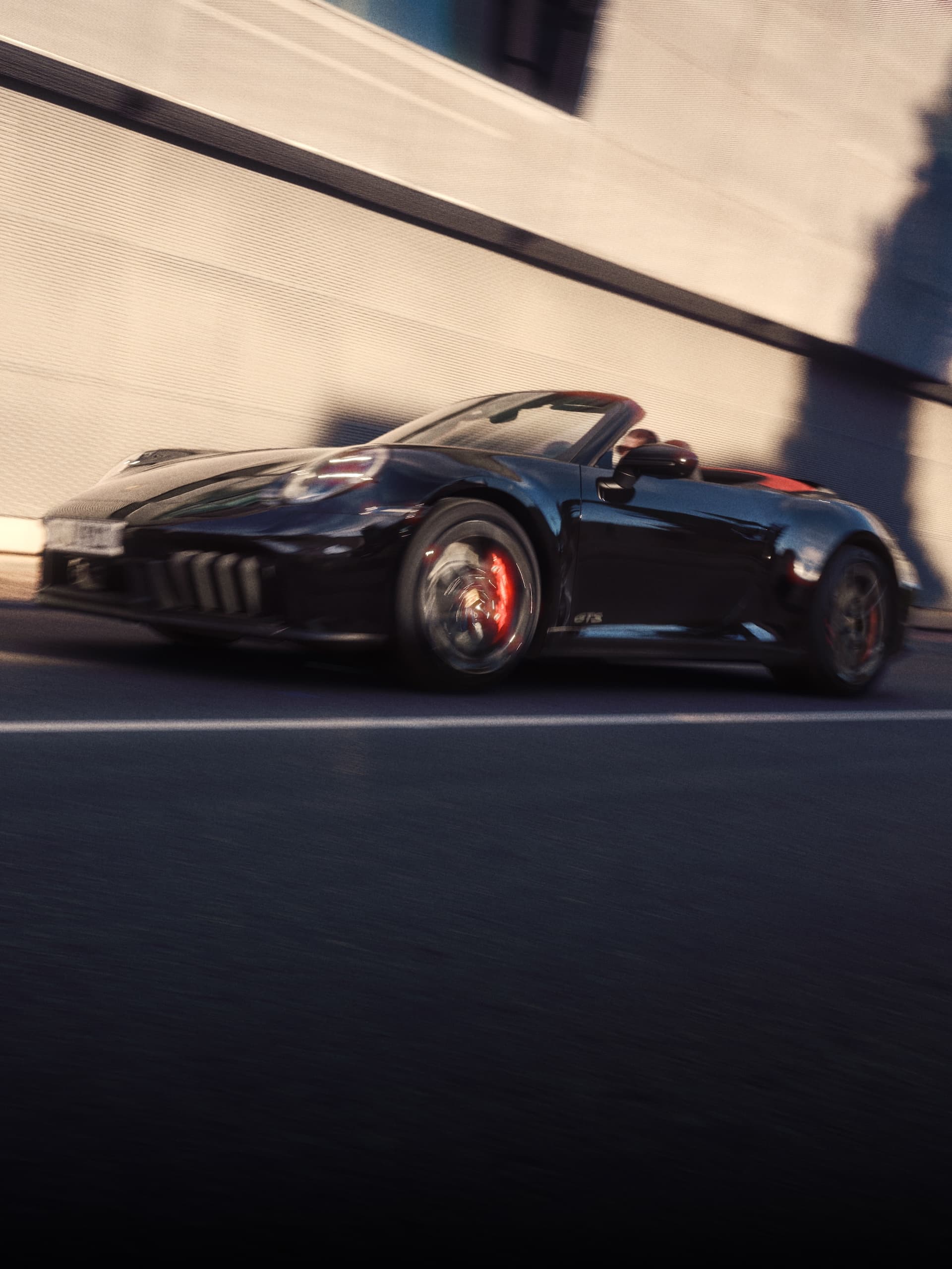 A Porsche 911 driving down a road.